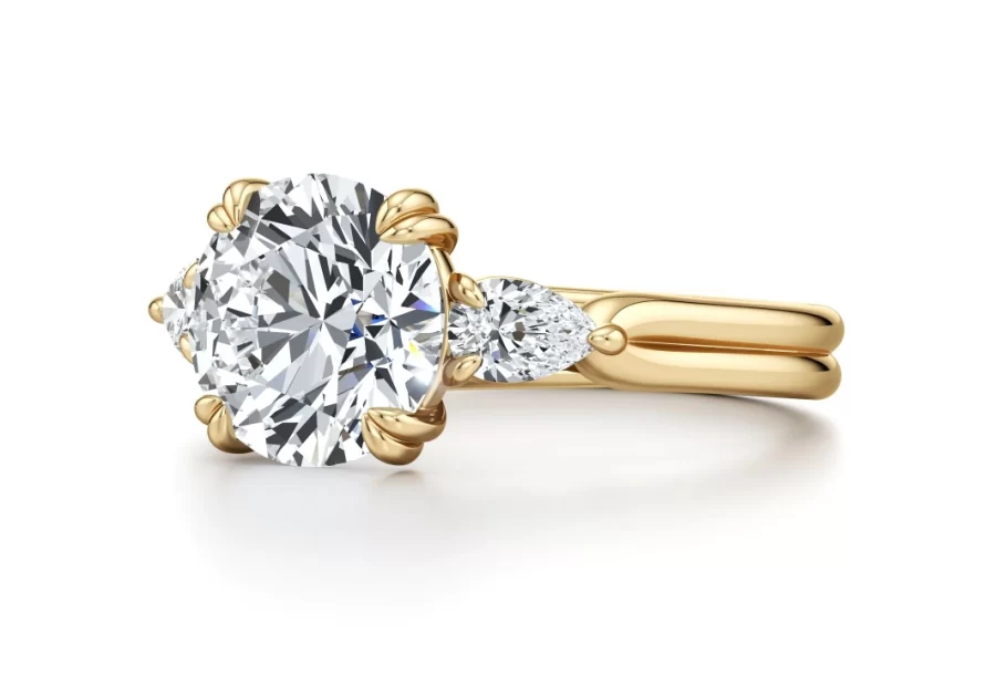 “Three-stone engagement ring featuring a lab-grown center diamond flanked by pear-shaped side stones in a double-prong setting, with a dual-row high-polished band—Ella Landon’s signature Marriah Ella design.”