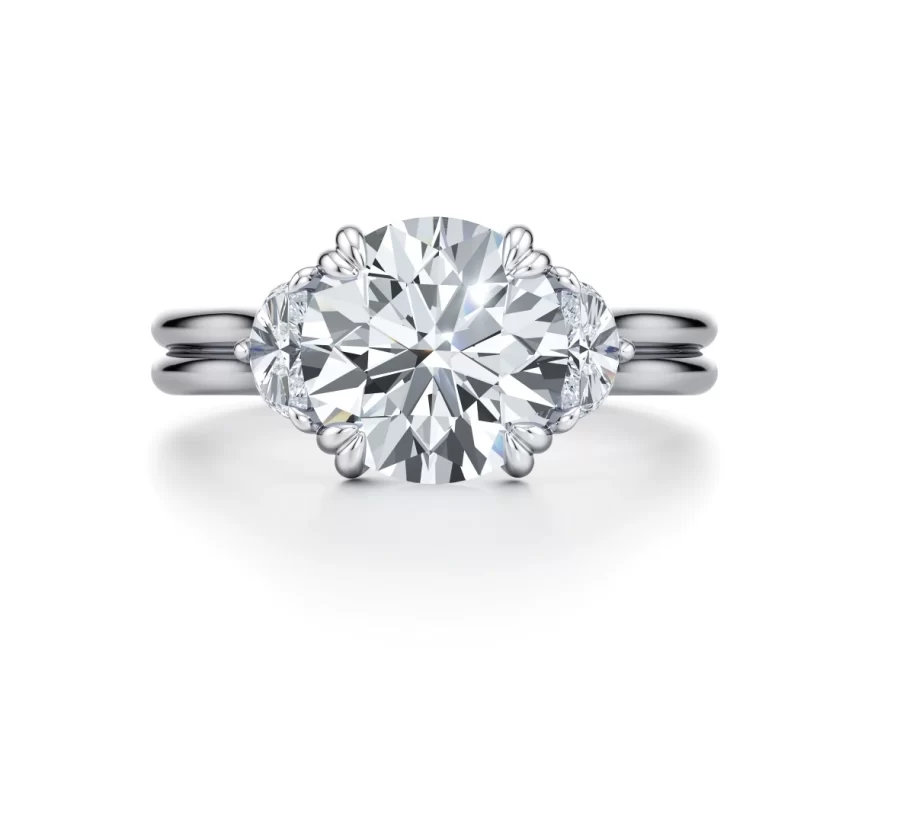 “Three-stone engagement ring featuring a lab-grown center diamond and two half-moon side stones in a double-prong setting, finished with a dual-row high-polished band—Jennifer by Ella Landon.”