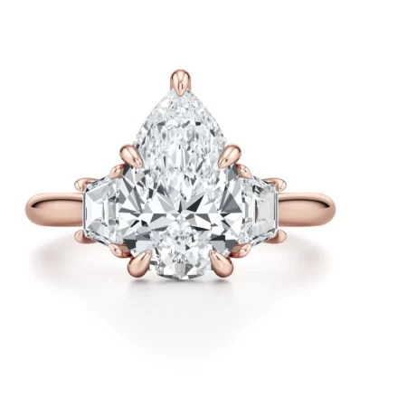 Chelseia — 4 Carat Pear‑Shaped Lab Diamond Three‑Stone Engagement Ring with Trapezoid Side Stones & Hidden Halo